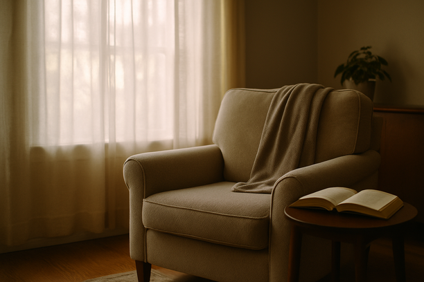 alt_text: A serene living room corner with soft morning light, a cozy armchair, and an open book on a table.