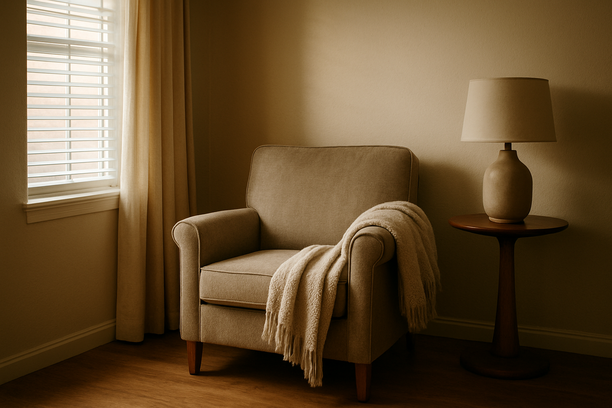 alt_text: A serene living room corner featuring an armchair and a cozy throw, bathed in soft afternoon light.