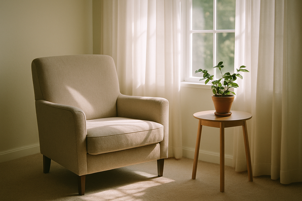 alt_text: A tranquil living room corner bathed in morning light, featuring a cozy chair and a plant.