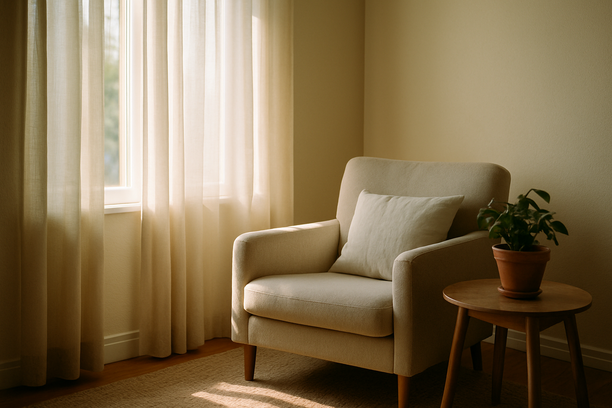alt_text: A cozy living room corner bathed in sunlight, featuring a chair and a potted plant.