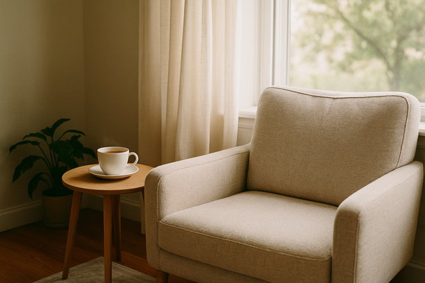 alt_text: A serene living room corner with a cozy chair and untouched tea, radiating calm and warmth.